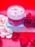 Crimson Kiss Collagen Body Butter from Discover Me Shop, elegantly showcased with vibrant red roses and petals. A rich, nourishing blend infused with collagen to deeply hydrate, firm, and rejuvenate the skin for a luxurious self-care experience."